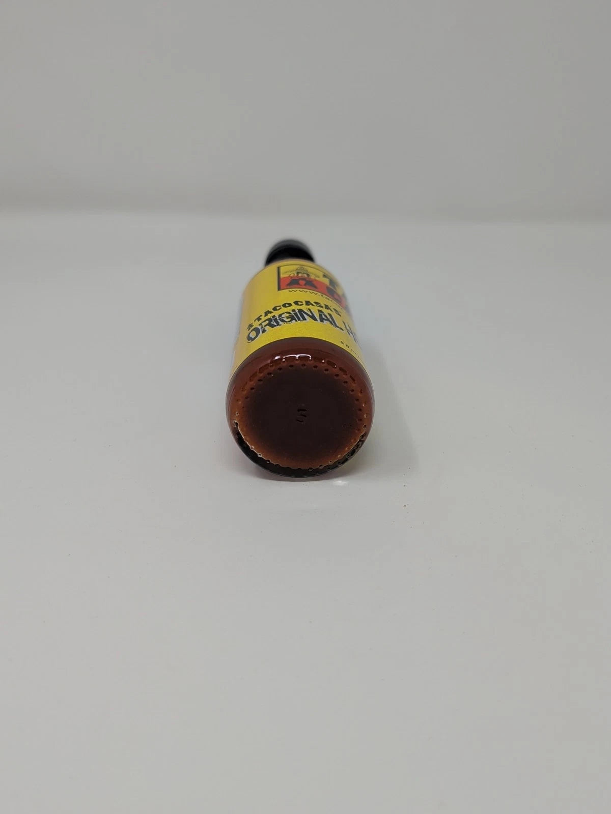 Taco Casa Hot Sauce bottle with a yellow label on a white background