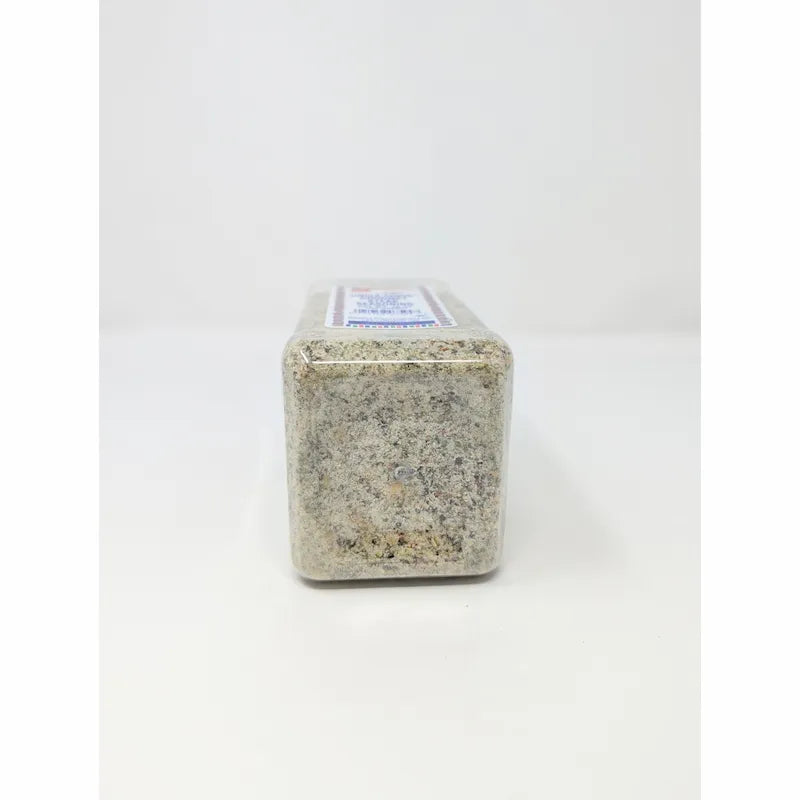 Bottom view of Uncle Chris Gourmet Steak Seasoning in a clear plastic shaker bottle with a white cap, on a white background.