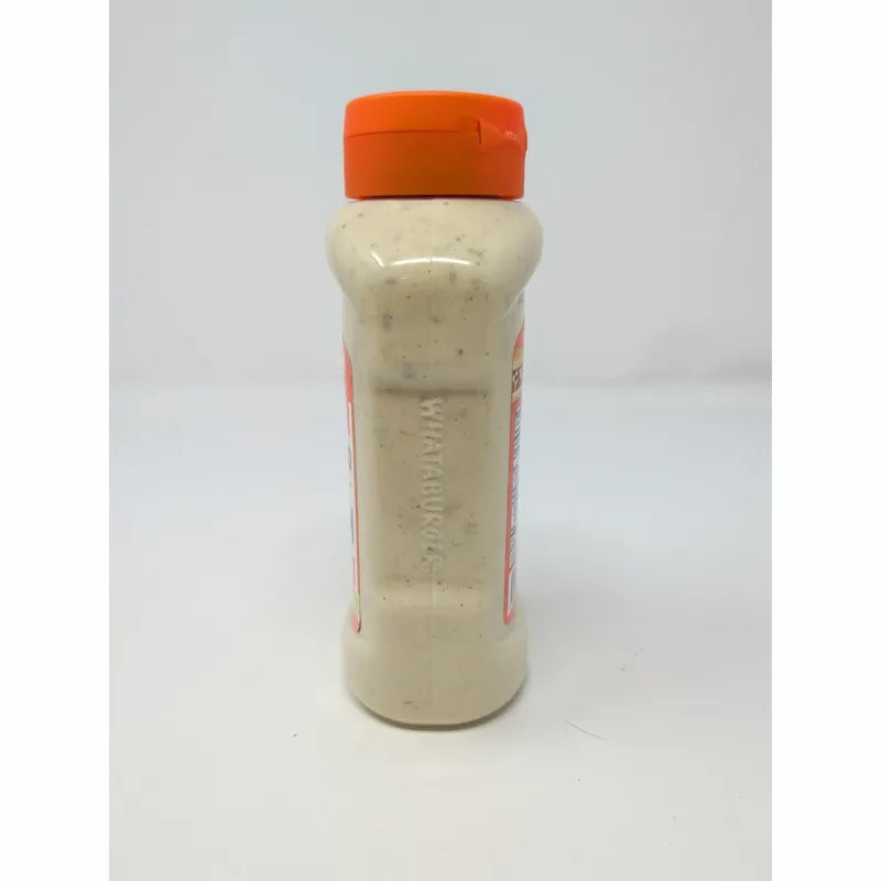 Side view of a bottle of Whataburger Signature Sauce with an orange cap and a white sauce inside and Whataburger embossed in the side plastic.