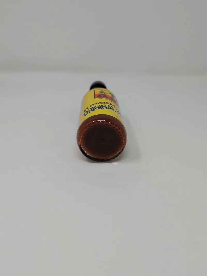 Taco Casa Hot Sauce bottle with a yellow label on a white background