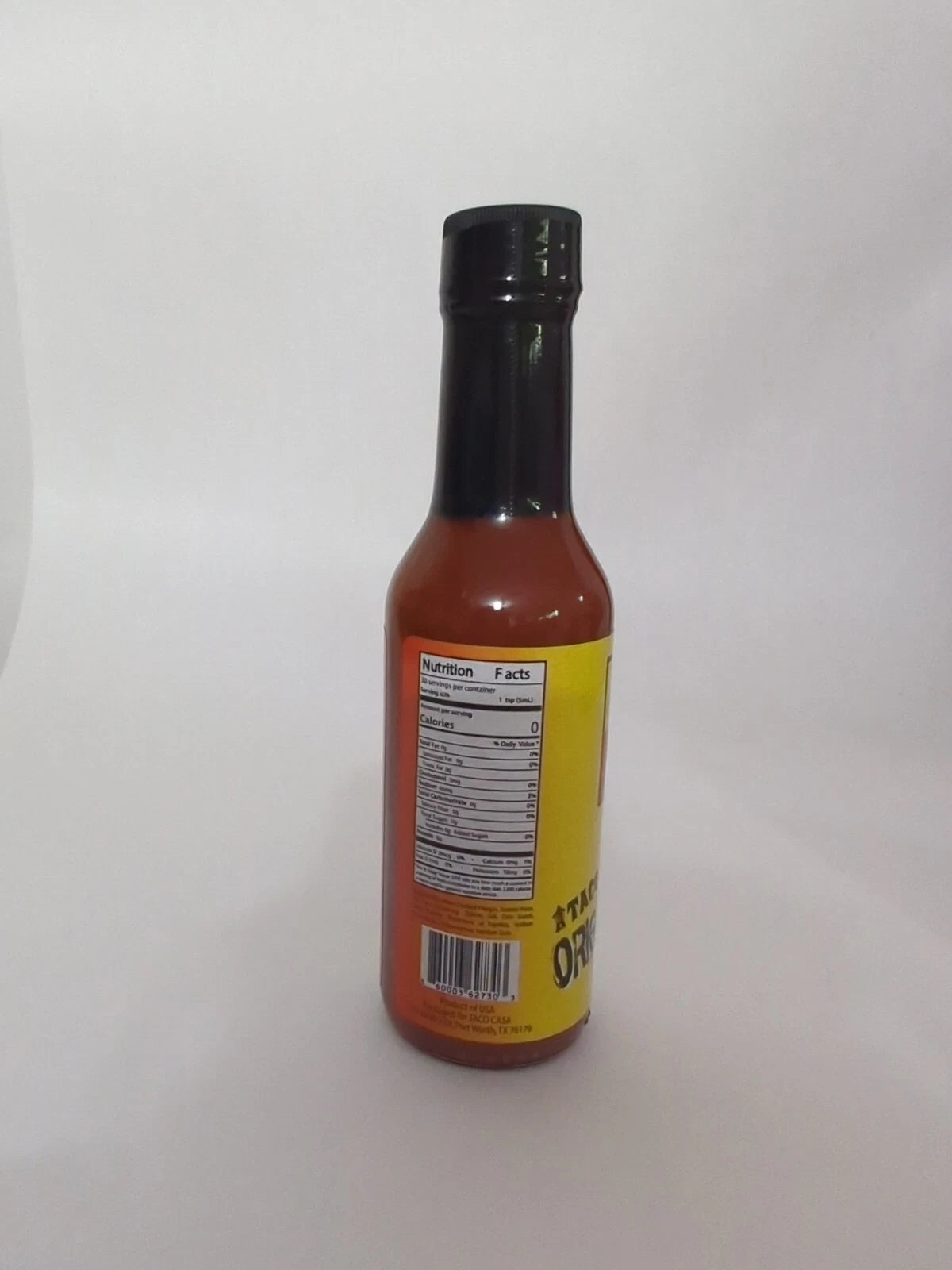 Taco Casa hot sauce bottle with nutirition facts label on a white background