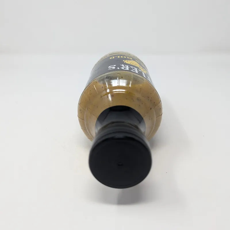 Top view of a bottle of Butler's Texas Gold Gourmet BBQ Sauce on a plain white background. The bottle is filled with a golden-brown sauce and features a black label with white and yellow text.