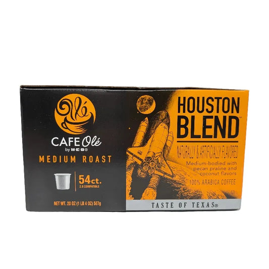 Front view of a box of Cafe Ole by HEB Houston Blend Medium Roast coffee pods, featuring a black and orange design with a space shuttle graphic and text indicating 54 count.