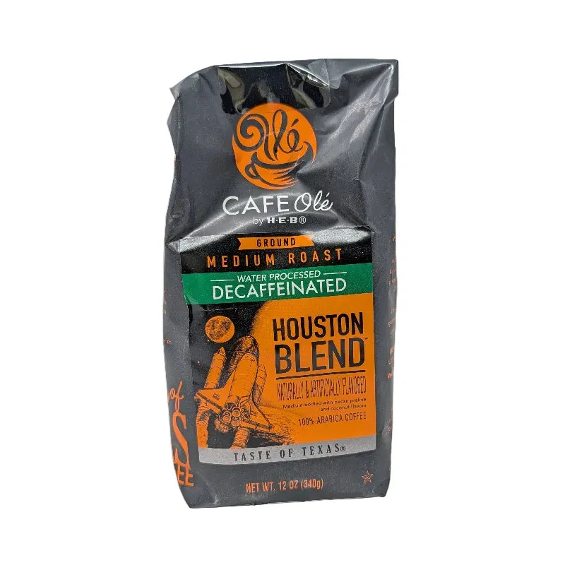 Front view of a 12 ounce bag of Cafe Ole by HEB Houston Blend Decaffeinated Ground Coffee. It features an orange and black color scheme with an image of the space shuttle on a white background.