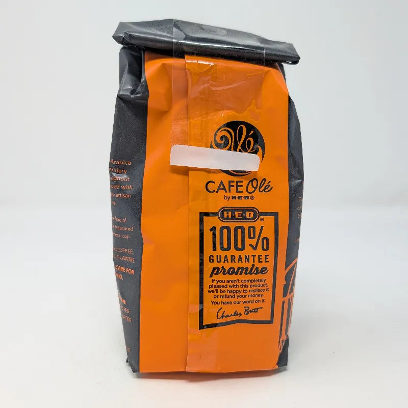 Rear view of a 12 ounce bag of Cafe Ole by HEB Houston Blend Decaffeinated Ground Coffee. It features an orange and black color scheme on a white background.