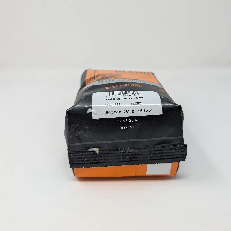 Bottom view of a 12 ounce bag of Hub City Blend medium roast ground coffee featuring an orange and black design scheme with a drawing of modern turbine windmills on a white background.