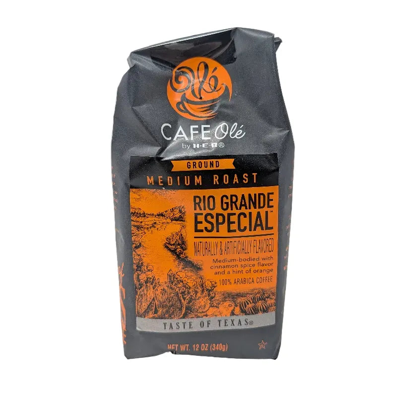 Front view of a 12 ounce bag of Cafe Ole by H-E-B Rio Grande Especial ground coffee featuring an orange and black color scheme on a plain white background.