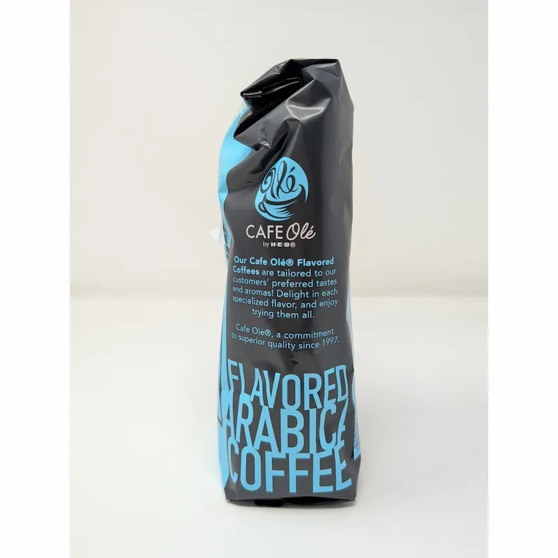 Side view of a 12 oz bag of Cafe Olé Texas Pecan ground coffee, medium roast, in a black bag with a blue label on a white background.