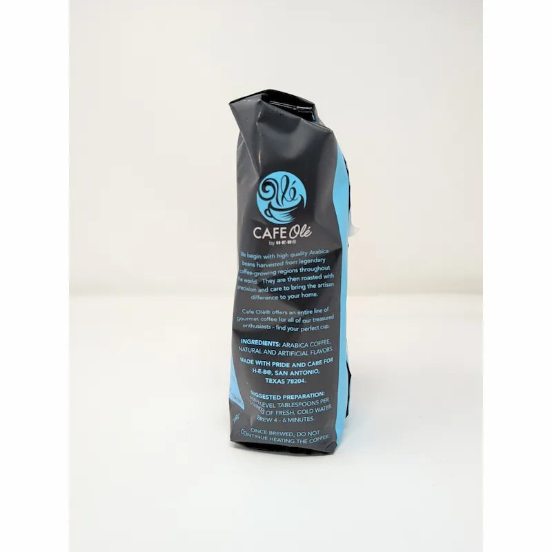 Side view of a 12 oz bag of Cafe Olé Texas Pecan ground coffee, medium roast, in a black bag with a blue label on a white background.