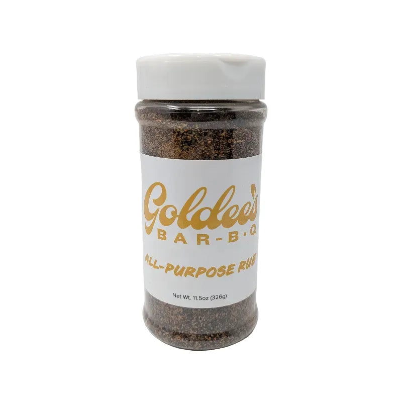 Front view of a clear plastic spice jar filled with dark brown all-purpose rub, featuring a white label with gold lettering that reads 'Goldee's Bar-B-Q' and 'ALL-PURPOSE RUB'. The jar has a white plastic lid and is photographed on a solid white background.