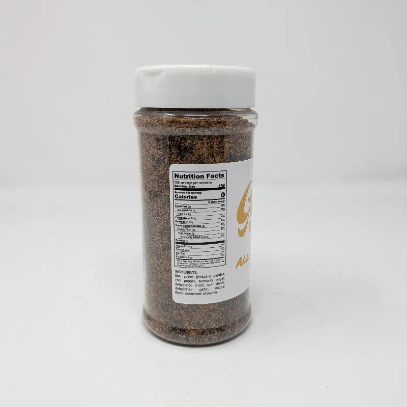 Side view of a clear plastic spice jar filled with dark brown all-purpose rub, featuring a white label with Nutrition Facts and ingredients list. The jar has a white plastic lid and is photographed on a solid white background.