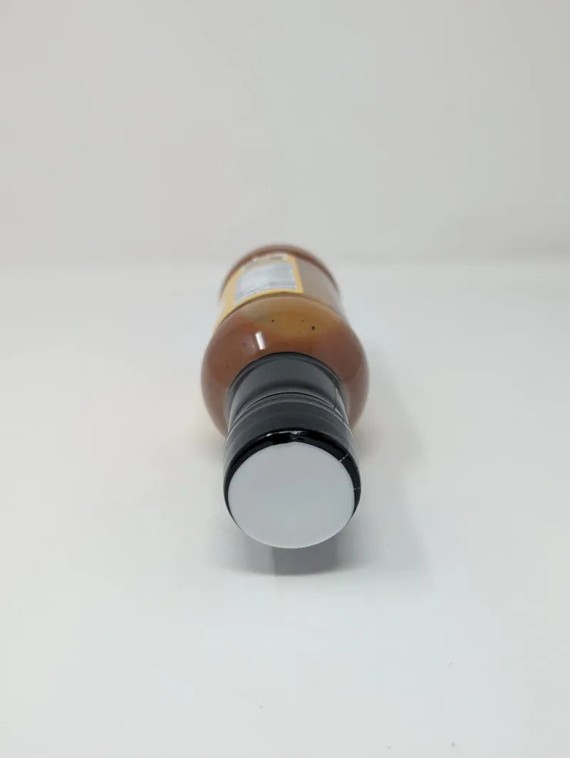 Top view of bottle of Goldie's Bar-B-Q Sauce on a white background