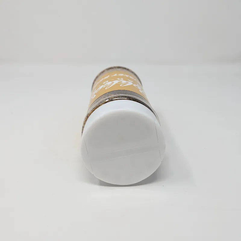 Top view of a shaker of Goldee's Bar-B-Q Brisket Rub  featuring a yellow label with white text and a white cap on a white background.
