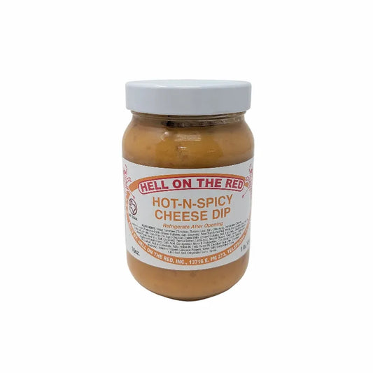 Front view of a jar of Hell on the Red Cheese Dip with a white label featuring yellow text and containing yellow queso on a white background.
