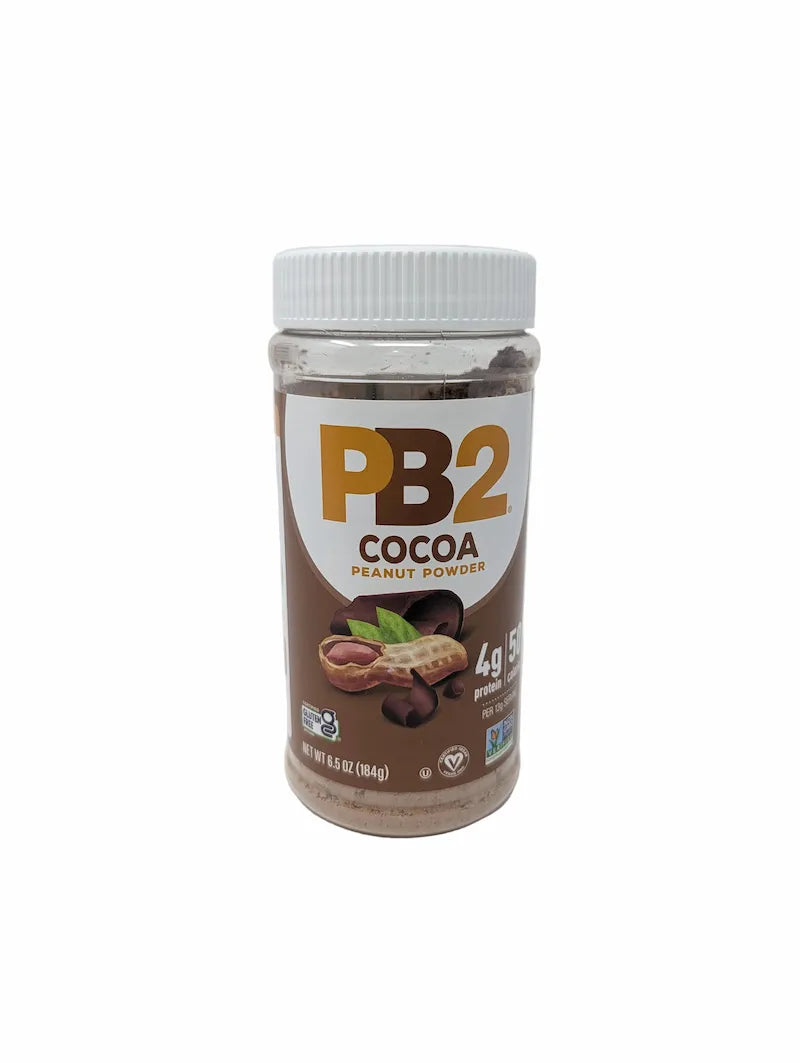 Front view of jar of PB2 Cocoa Peanut Powder on a plain white background. The product is in a clear plastic jar showing the brown powder inside, with a white ribbed lid and a brown and white label featuring the PB2 logo and cocoa bean illustrations.
