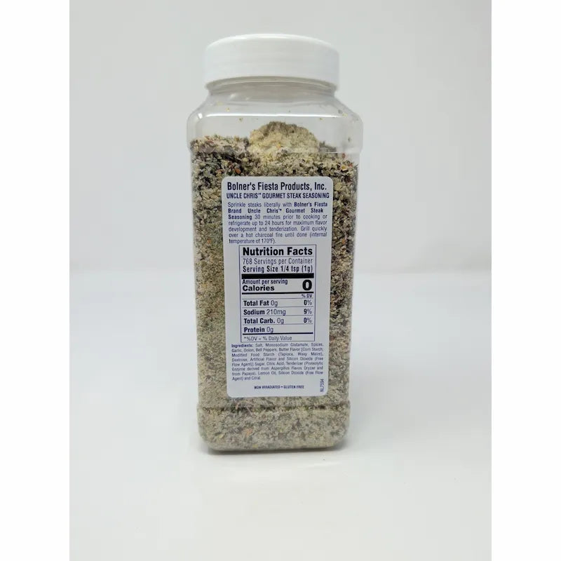 Rear view of Uncle Chris Gourmet Steak Seasoning in a clear plastic shaker bottle with a white cap, on a white background.