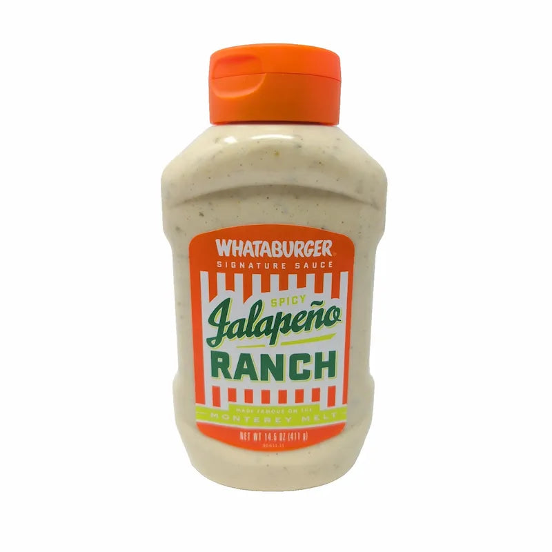 Front view of a bottle of Whataburger Signature Sauce Jalapeño Ranch hot sauce, featuring a white sauce inside a clear plastic bottle with an orange cap and a colorful orange, white, and green label.