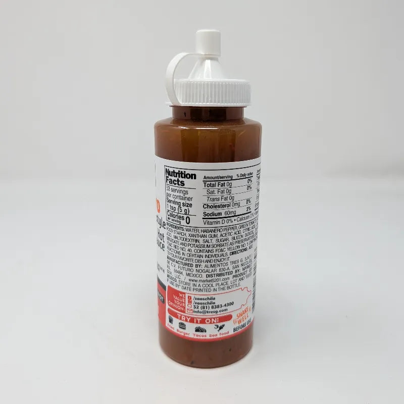 Side view of a bottle of Zaaschila Habanero Homestyle Hot Sauce on a plain white background featuring Nutrition Facts and ingredients. The bottle has a white cap with a built-in loop, and features a label with red, white, and black colors showing peppers and a bowl of sauce.