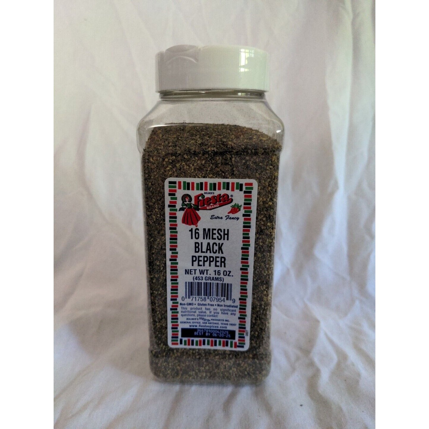 Bottle of 16 mesh black pepper on a white background